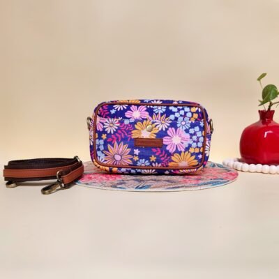Flora Charm Printed Sling Bag - Front View - Vibrant floral crossbody with Club To Clutch logo