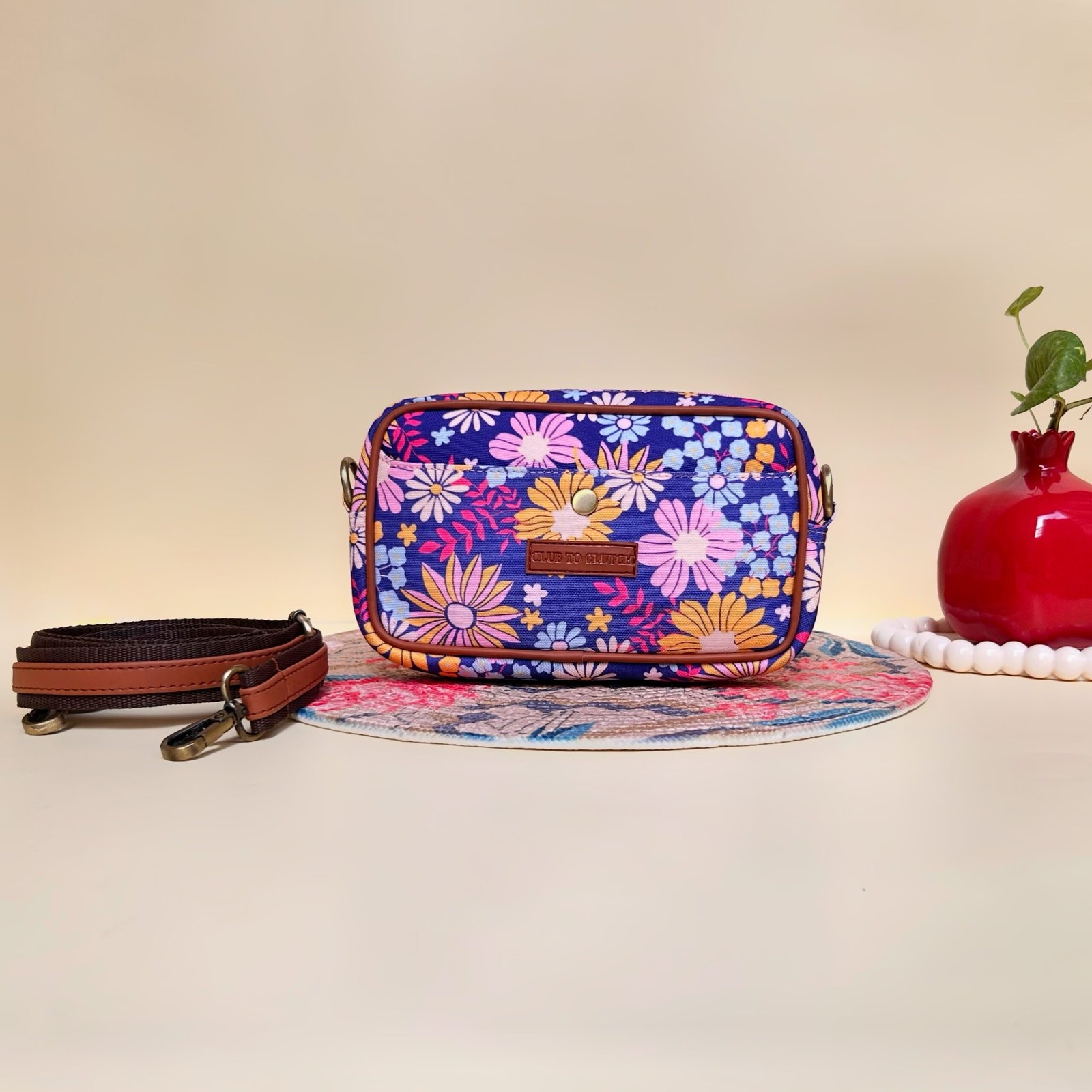 Flora Charm Printed Sling Bag - Front View - Vibrant floral crossbody with Club To Clutch logo
